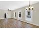 Open-concept living room with hardwood floors and neutral paint at 5845 Rawles Ave, Indianapolis, IN 46219