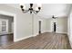 Open-concept living room with hardwood floors and natural light from a window at 5845 Rawles Ave, Indianapolis, IN 46219