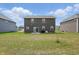 Large backyard of two-story home showing the green space, landscaping, and patio area at 211 Walker Dr, Whiteland, IN 46184