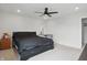 A calming bedroom featuring neutral walls, ceiling fan, and a view into the bathroom at 211 Walker Dr, Whiteland, IN 46184