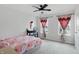 Bright bedroom showcasing two windows, plush carpet, and a fan fixture at 211 Walker Dr, Whiteland, IN 46184