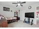 Well-lit bedroom with gray carpet, ceiling fan, a closet, and TV with stand at 211 Walker Dr, Whiteland, IN 46184