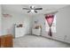 Well-lit bedroom features plush carpet, natural light from the windows, and ceiling fan at 211 Walker Dr, Whiteland, IN 46184