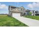Two-story home featuring a well-manicured lawn and long driveway at 211 Walker Dr, Whiteland, IN 46184