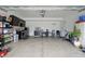 Organized garage with ample storage, black cabinets, room for parking, and work space at 211 Walker Dr, Whiteland, IN 46184
