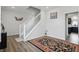Hallway with white staircase, hardwood floors, and stylish wall art at 211 Walker Dr, Whiteland, IN 46184