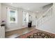 Bright living room features wood floors, staircase, and natural light at 211 Walker Dr, Whiteland, IN 46184