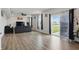 Spacious living room featuring modern gray sofas, a ceiling fan, and sliding doors to the outside at 211 Walker Dr, Whiteland, IN 46184