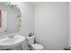 Charming half bathroom with pedestal sink and decorative mirror at 211 Walker Dr, Whiteland, IN 46184