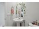 Tasteful powder room with a pedestal sink and framed mirror at 211 Walker Dr, Whiteland, IN 46184
