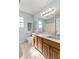 Double vanity bathroom with wood cabinets and updated fixtures at 6093 Boulder Ct, Columbus, IN 47201