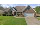 Brick ranch house with attached garage and landscaped lawn at 6093 Boulder Ct, Columbus, IN 47201