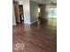 Spacious living room featuring hardwood floors and an open layout to the kitchen area at 2456 Beechcrest Dr, Indianapolis, IN 46203