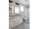 Bathroom with double vanity, granite countertop, and bathtub at 5286 Stonehaven Ln, Columbus, IN 47201
