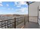 Private balcony showcasing scenic neighborhood views, metal railings, and wood-look flooring at 1155 S Rangeline Rd # 507, Carmel, IN 46032