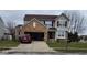 Inviting two-story home featuring a brick facade, attached garage, and well-maintained front lawn at 6951 Governors Point Blvd, Indianapolis, IN 46217