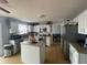 Bright kitchen with white cabinets, stainless steel appliances, a center island, and open dining space at 6951 Governors Point Blvd, Indianapolis, IN 46217