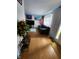 Comfortable living room featuring hardwood floors, modern entertainment center, and ample natural light at 6951 Governors Point Blvd, Indianapolis, IN 46217