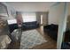 Spacious living room with hardwood floors, large rug, comfortable couches, and ample natural light at 6951 Governors Point Blvd, Indianapolis, IN 46217