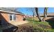 Large backyard featuring a brick house, patio and a wood fence at 3230 Meadowcrest Dr, Anderson, IN 46011