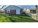 Backyard featuring a detached garage with white doors and a partially fenced in yard at 3230 Meadowcrest Dr, Anderson, IN 46011