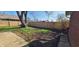 Expansive backyard featuring a wood fence, lush lawn, and mature trees at 3230 Meadowcrest Dr, Anderson, IN 46011
