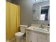 Bathroom featuring a yellow shower curtain, a toilet, and a vanity sink at 3230 Meadowcrest Dr, Anderson, IN 46011