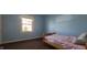 Cozy bedroom with light blue walls, carpet, and a sunlit window at 3230 Meadowcrest Dr, Anderson, IN 46011