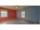 Bedroom featuring an orange wall, a blue wall, carpet, and two windows offering outdoor views at 3230 Meadowcrest Dr, Anderson, IN 46011