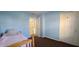 Light blue bedroom featuring carpeting, a window, a closet, and a view into another room at 3230 Meadowcrest Dr, Anderson, IN 46011