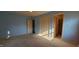 Light blue bedroom with carpet, a closet, and an open doorway to a bathroom at 3230 Meadowcrest Dr, Anderson, IN 46011