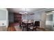 Traditional dining room featuring hardwood floors, a decorative chandelier, and a brick fireplace at 3230 Meadowcrest Dr, Anderson, IN 46011