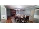 Traditional dining room featuring hardwood floors, a decorative chandelier, and a brick fireplace at 3230 Meadowcrest Dr, Anderson, IN 46011