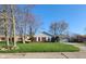 Classic brick home featuring a lush green lawn and attached garage at 3230 Meadowcrest Dr, Anderson, IN 46011