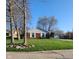 Traditional brick home with green lawn, white shutters, and attached garage at 3230 Meadowcrest Dr, Anderson, IN 46011