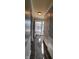 Welcoming hallway with neutral paint and hardwood floors, offering a glimpse of the front door at 3230 Meadowcrest Dr, Anderson, IN 46011