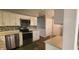 Well-lit kitchen with stainless steel appliances, white cabinets, and stylish backsplash at 3230 Meadowcrest Dr, Anderson, IN 46011