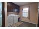 Laundry area featuring modern washer and dryer, cabinets, and a window for natural light at 3230 Meadowcrest Dr, Anderson, IN 46011