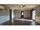 Open living room with hardwood floors, neutral paint, and natural light from the glass door at 3230 Meadowcrest Dr, Anderson, IN 46011