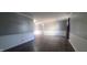 Spacious living room showcasing gray walls, white trim, wood-look floors, and ample space at 3230 Meadowcrest Dr, Anderson, IN 46011