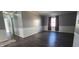 A living room with hardwood floors, wainscoting, and gray walls providing an open concept at 3230 Meadowcrest Dr, Anderson, IN 46011