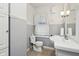 Small bathroom with toilet, sink, and window at 1185 N 10Th St, Noblesville, IN 46060