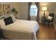 Cozy bedroom featuring a comfortable bed with elegant decor, window, chair, and side table at 1185 N 10Th St, Noblesville, IN 46060