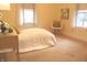 Bright bedroom with neutral tones, plush carpeting, and a cozy chair at 1185 N 10Th St, Noblesville, IN 46060