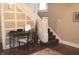 Light-filled entryway showcases a wooden desk and staircase with white trim and wainscoting at 1185 N 10Th St, Noblesville, IN 46060