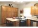 Spacious kitchen with wooden cabinets, island with bar seating, and stainless steel appliances at 1185 N 10Th St, Noblesville, IN 46060