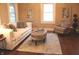Inviting living room featuring a comfortable sofa, stylish chair, ottoman, and hardwood floors at 1185 N 10Th St, Noblesville, IN 46060