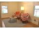 Cozy living room featuring patterned chairs, a round table, and natural light, offering a comfortable setting at 1185 N 10Th St, Noblesville, IN 46060