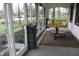 Inviting screened porch with a cozy swing, coffee table, and decorative sunflower centerpiece at 1185 N 10Th St, Noblesville, IN 46060
