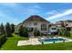 An expansive backyard with an inviting pool, comfortable seating, and mature trees at 11492 Hanbury Manor Blvd, Noblesville, IN 46060